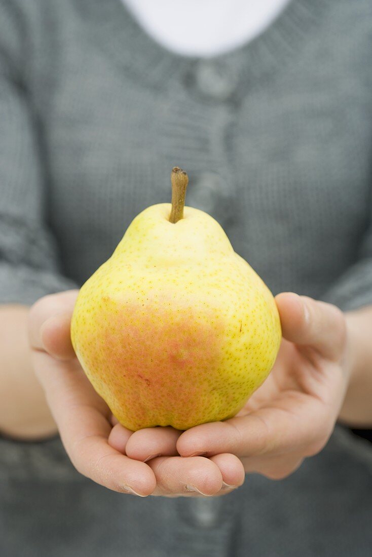 Woman holding Williams pear