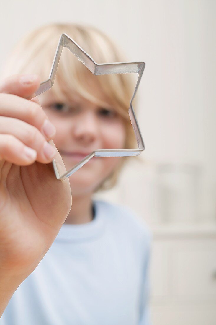 Boy holding biscuit cutter