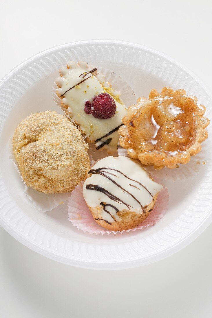 Assorted sweet pastries on plastic plate