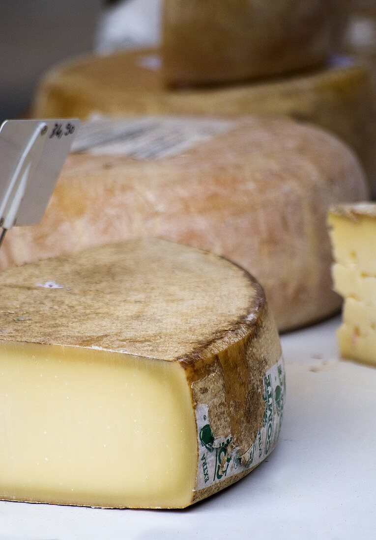 Various cheeses on a market stall