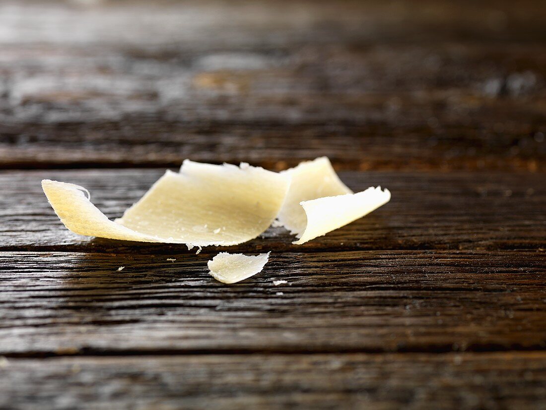 Parmesan shavings on wooden background