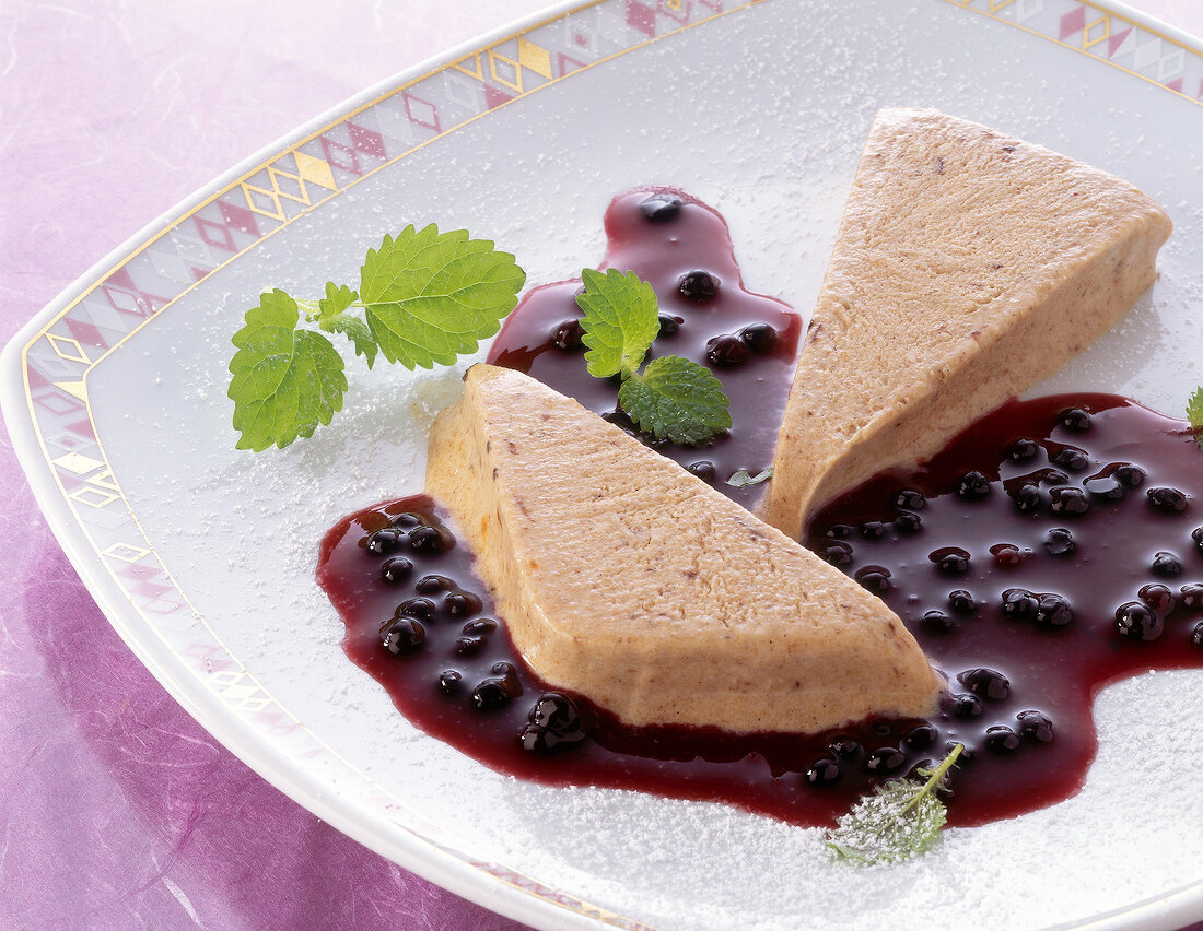 Plum parfait with elderberry sauce on plate