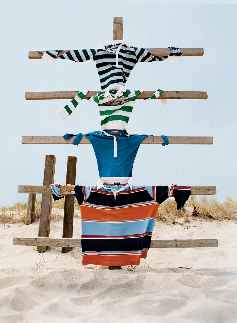 Shirts hanging on wooden stand on Baltic sea coast