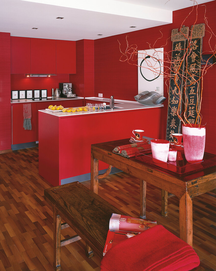 View of red asian style kitchen furnished kitchen with bar counter and parquet flooring