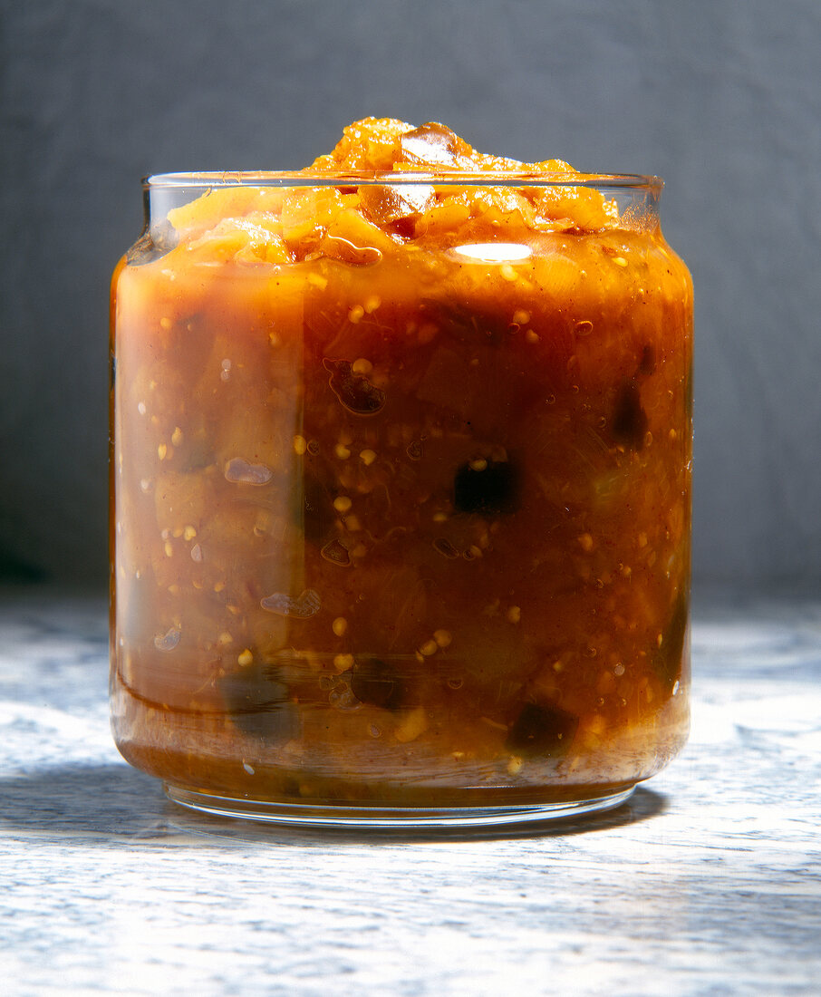 Spicy chutney with pineapple and eggplant in glass jar