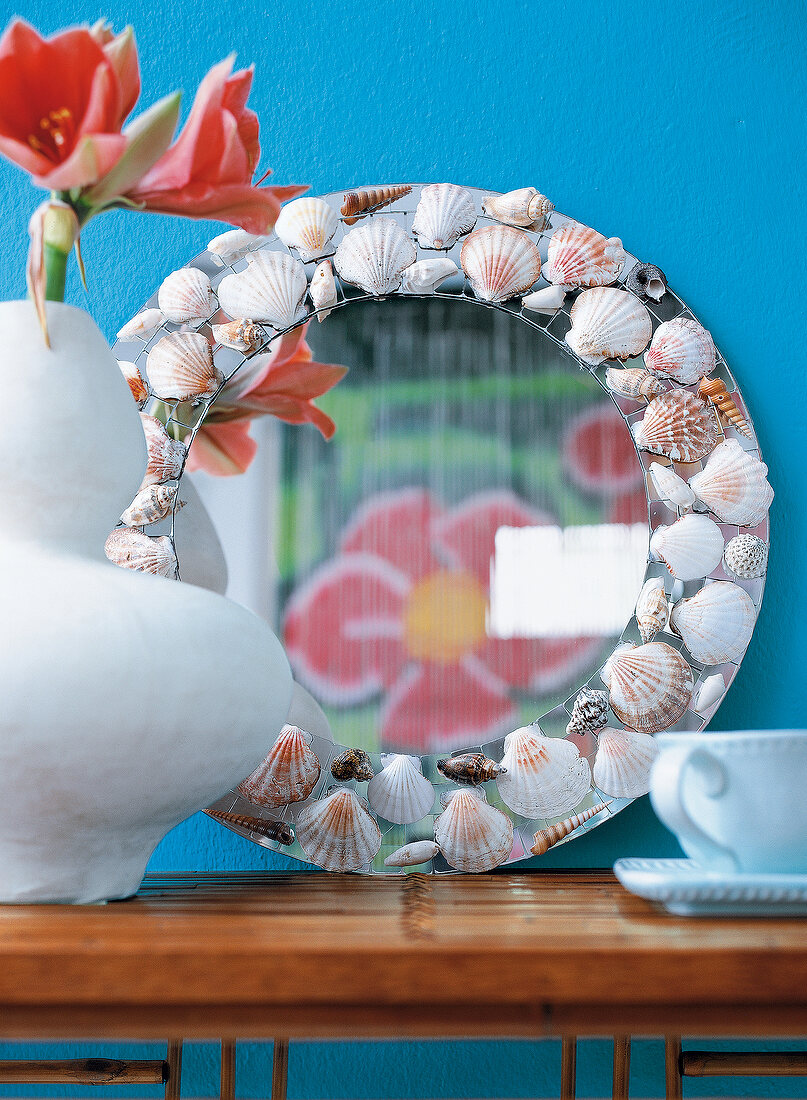 Close-up of tranby mirror with various shells on border