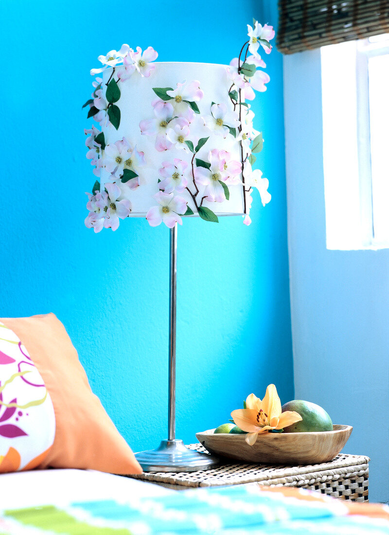 Close-up of white floor lamp decorated with pink flowers made of cloth