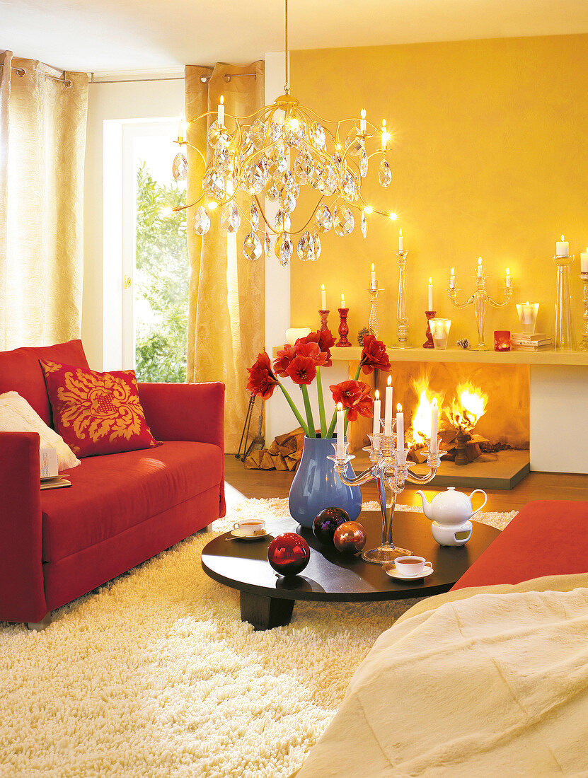 Interiors of living room with glass chandelier, sofa and fireplace