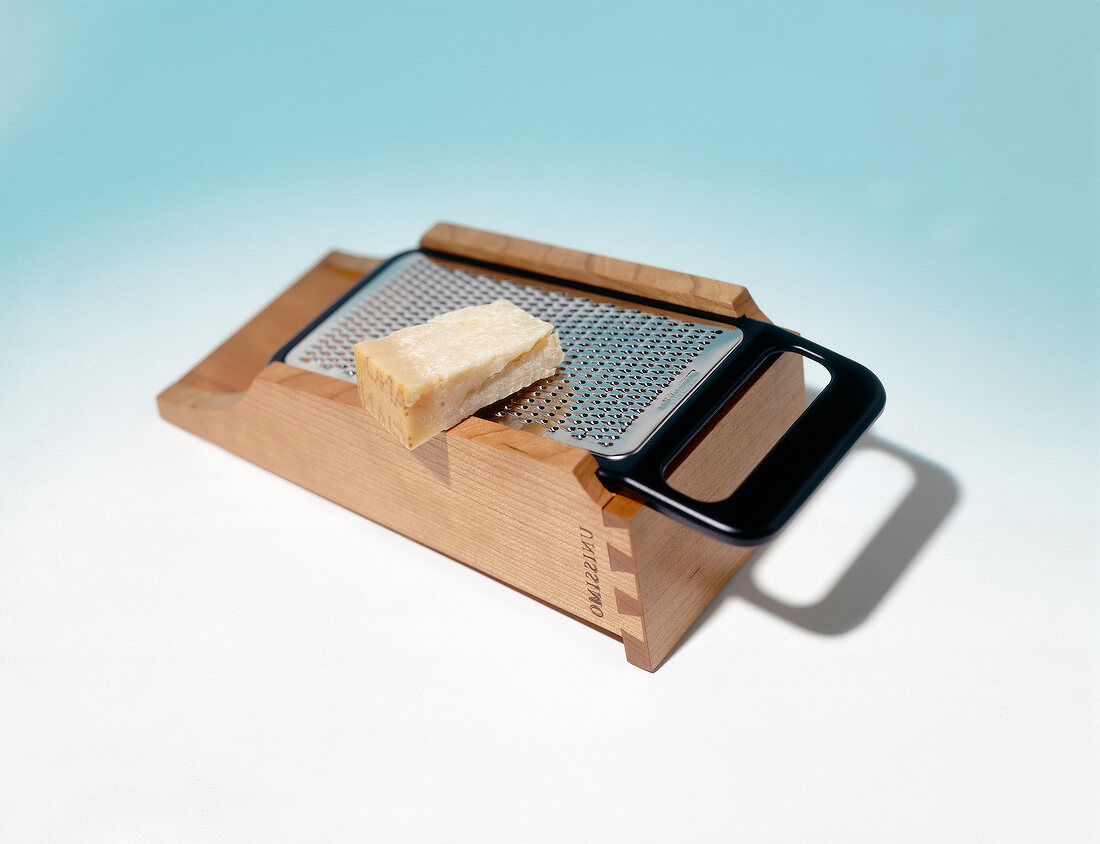 Parmesan grater on blue background