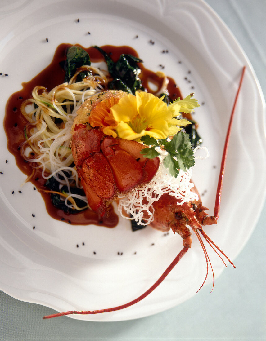 Close-up of roasted lobster with chinese vegetables on plate