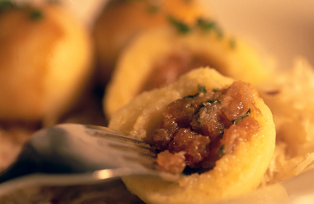 Viennese specialty - greaves dumplings filled with fried bacon pieces, close-up
