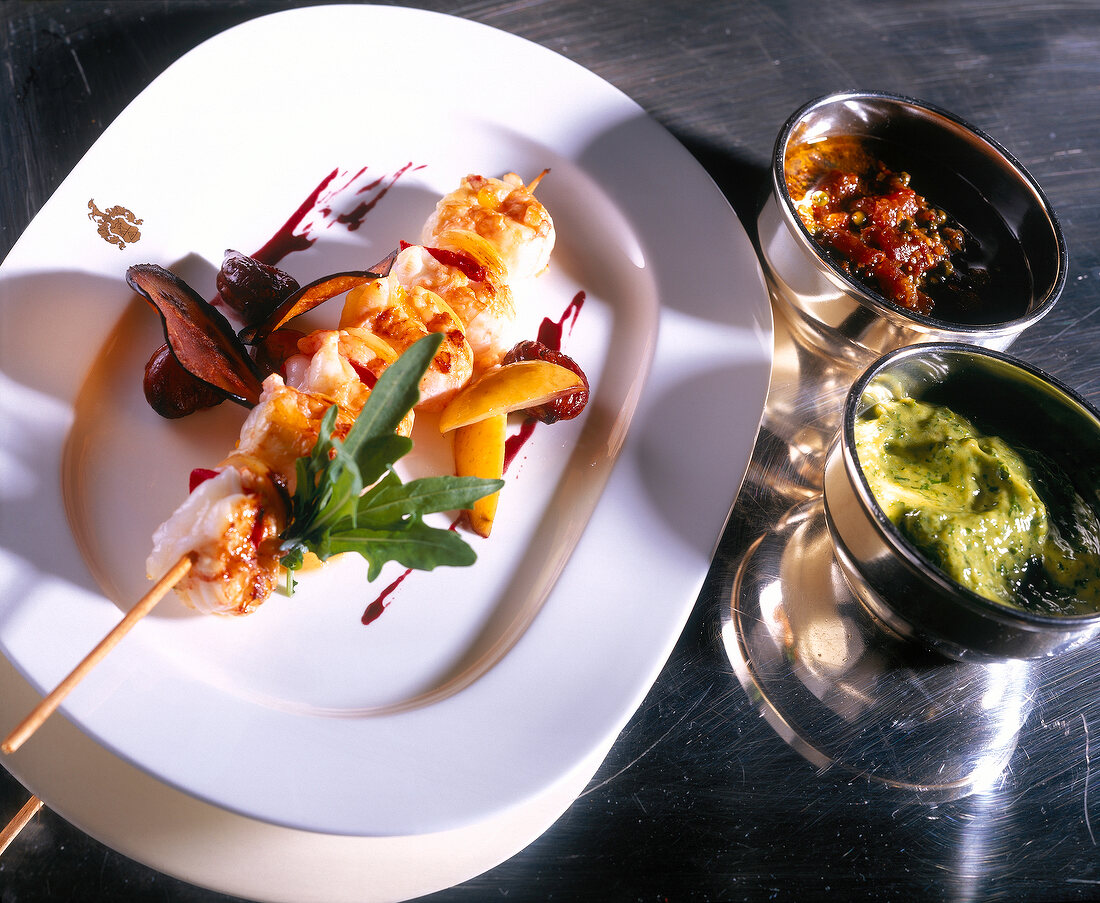 Barbecue of prawns with two sauces on plate