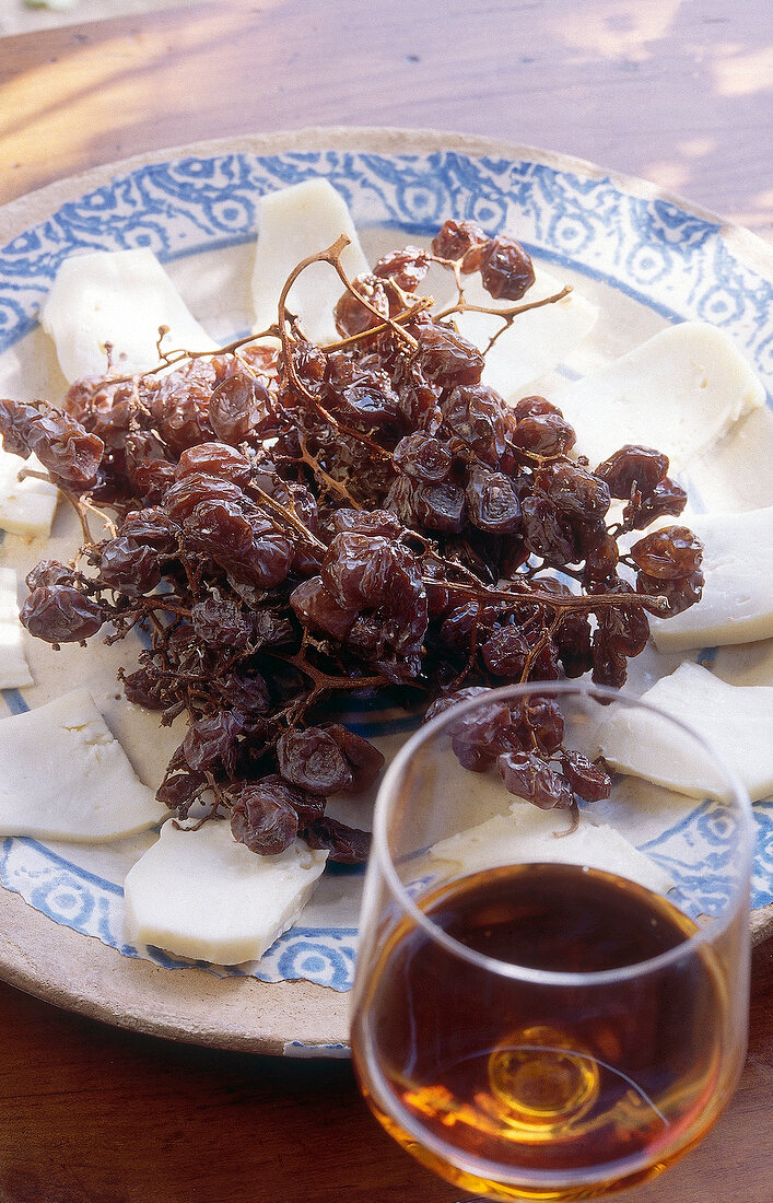 Dried grapes with taleggio cheese on plate