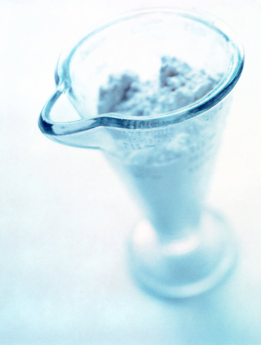 Close-up of glass measuring jug on white background