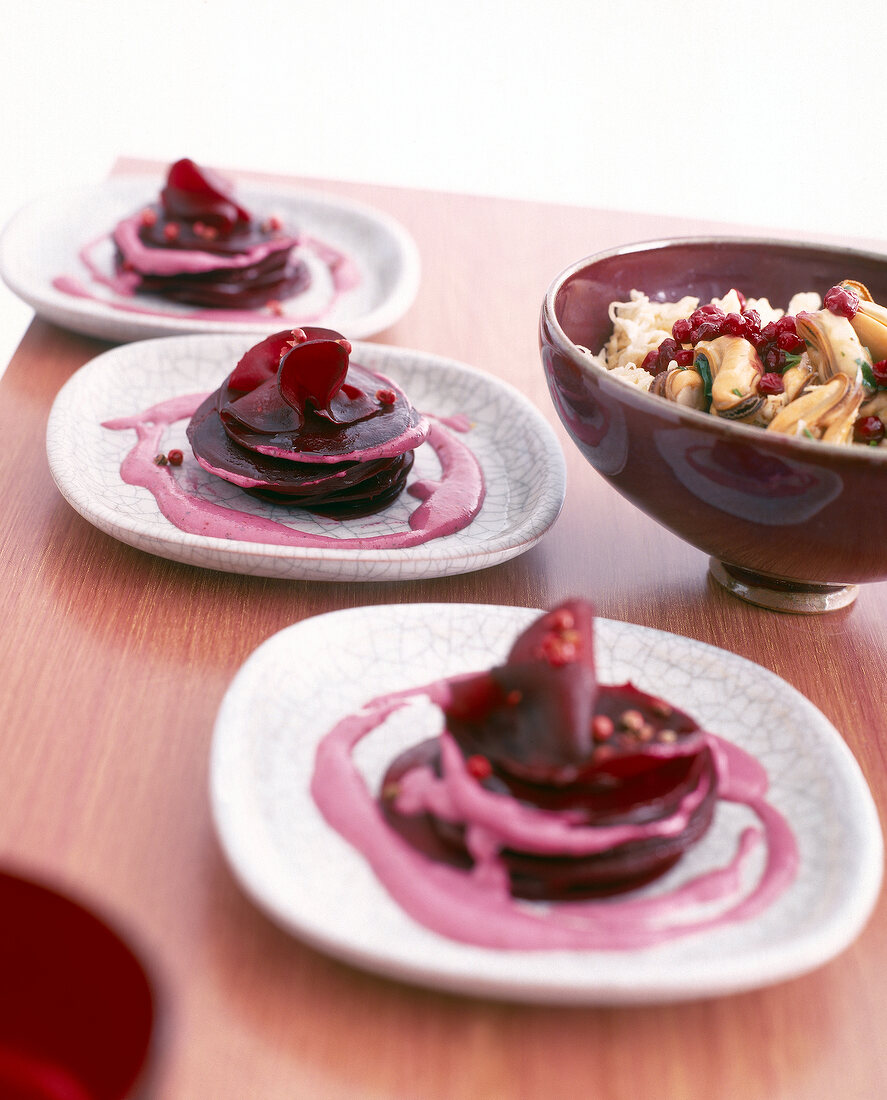 Mussels beetroot carpaccio with mint pesto on plates