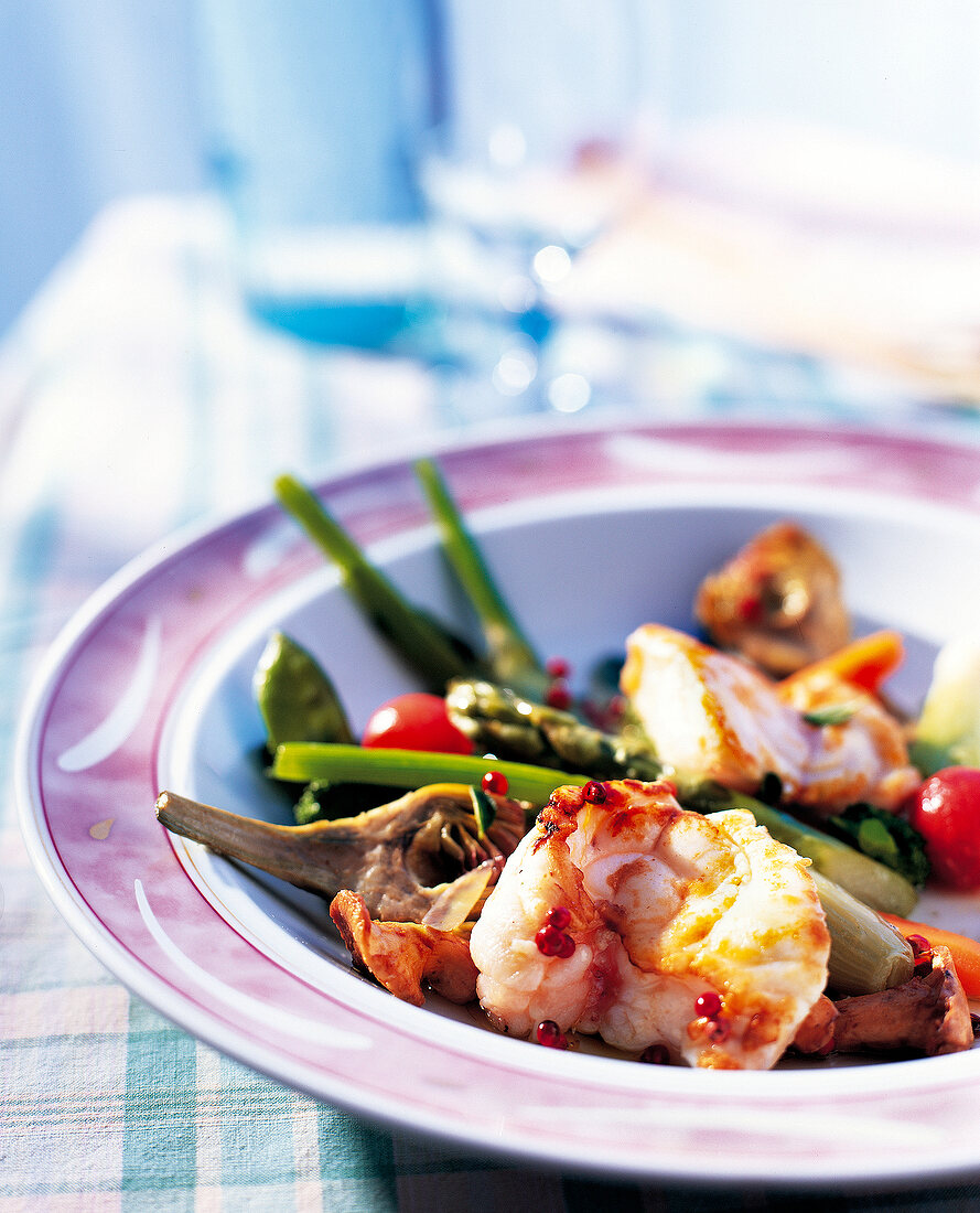Monkfish with spring vegetables on a plate