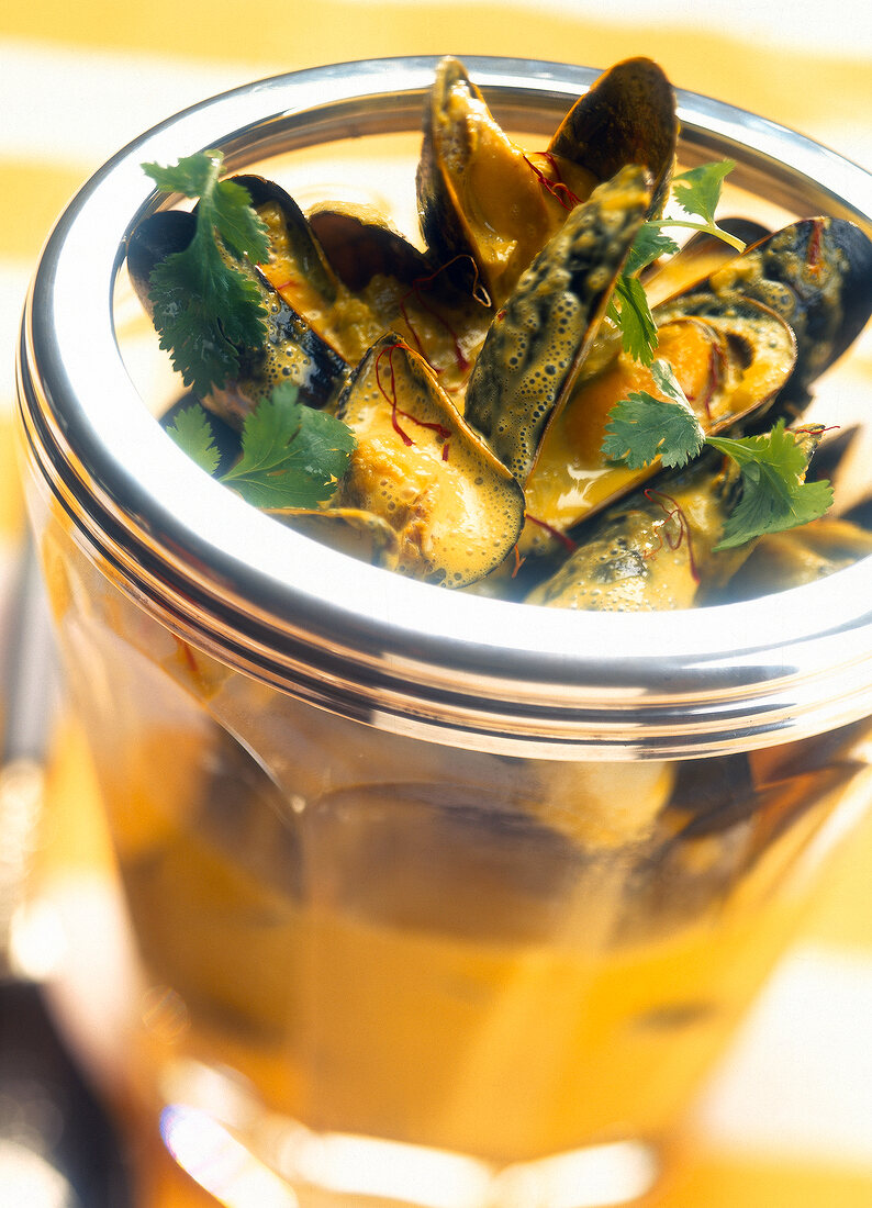 Close-up of bouchot mussels with saffron and fennel curry in glass