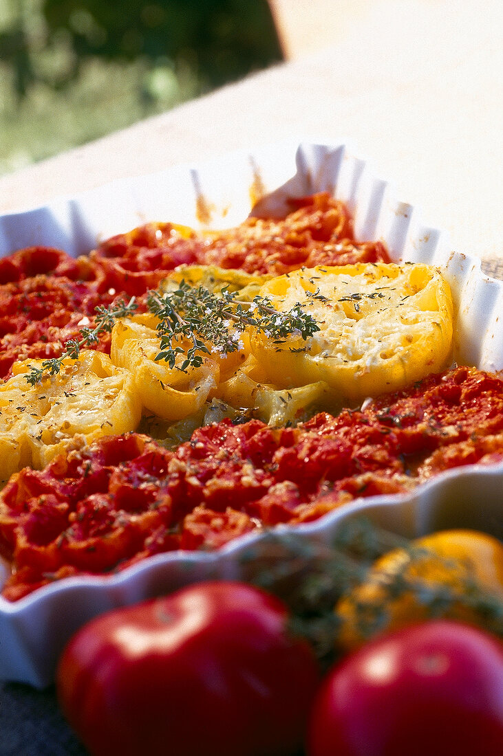 Yellow and red tomatoes cut into pieces in baking dish