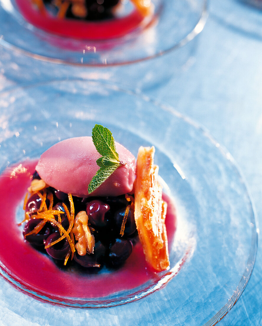 Apricot tart with cherry ice cream on glass plate