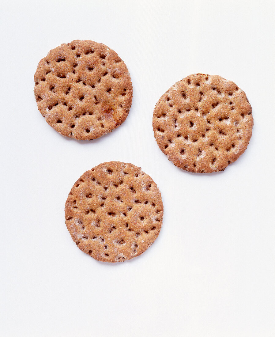 Three round crisp bread on white background