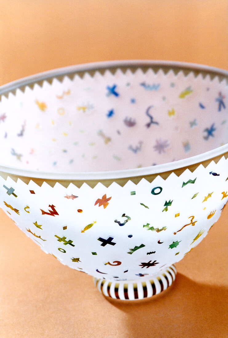 Close-up of glass bowl with multi-coloured patterns