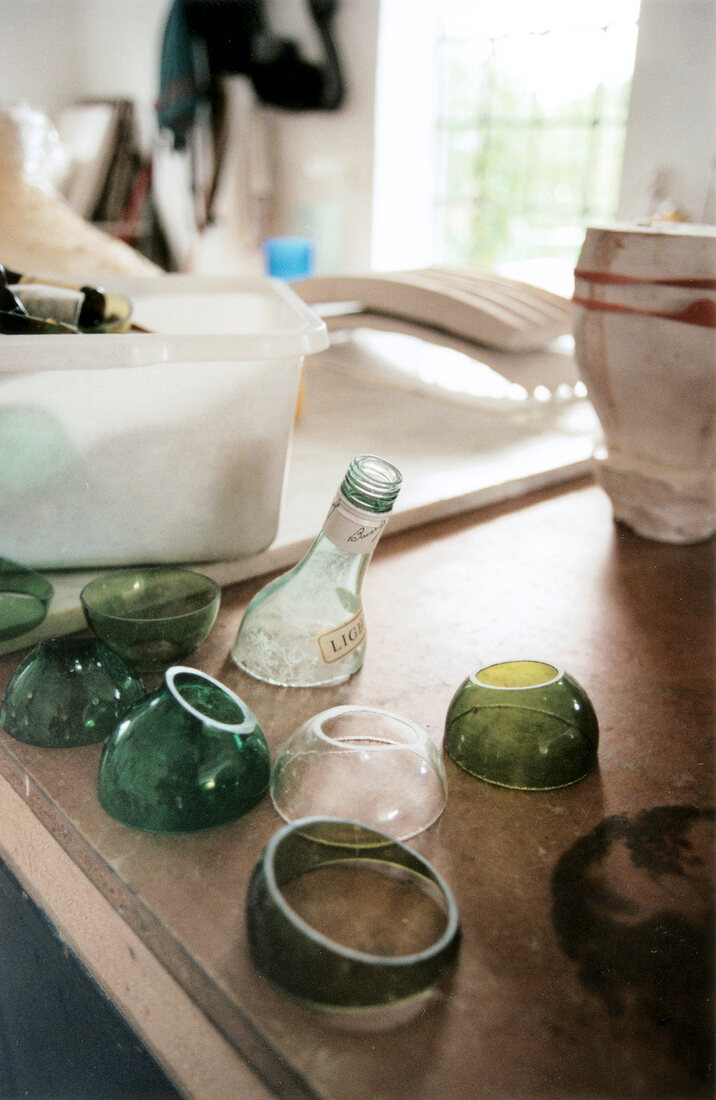 Sawing glass bottles in workshop