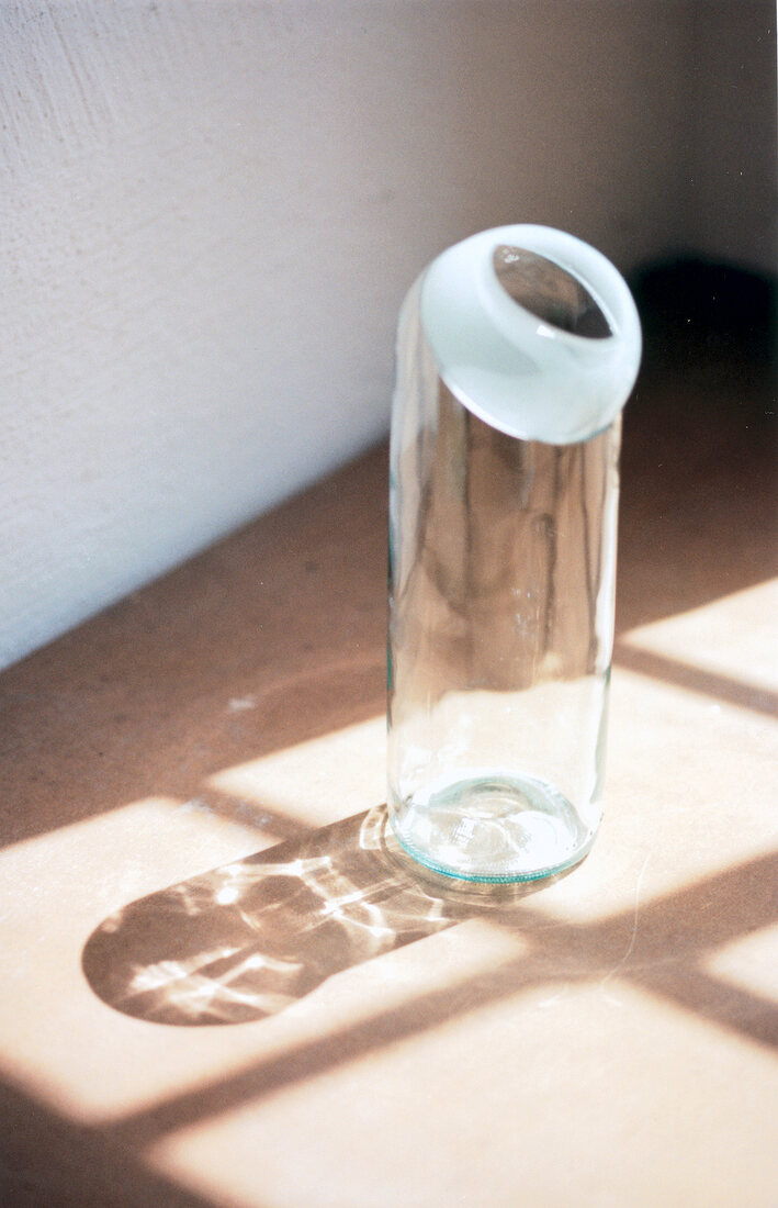Small white flower vase on floor