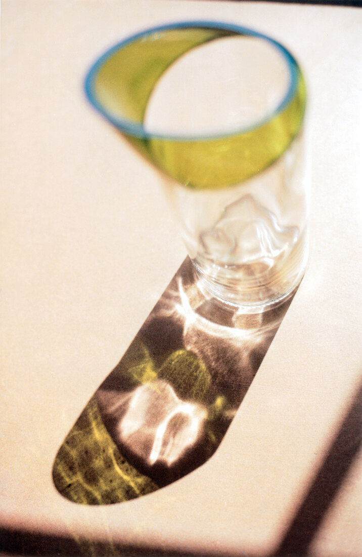 Close-up of green vase with water on white background