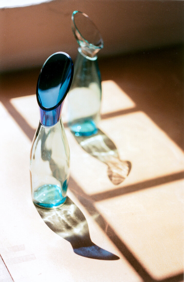 Close-up of two blue designer vase on floor