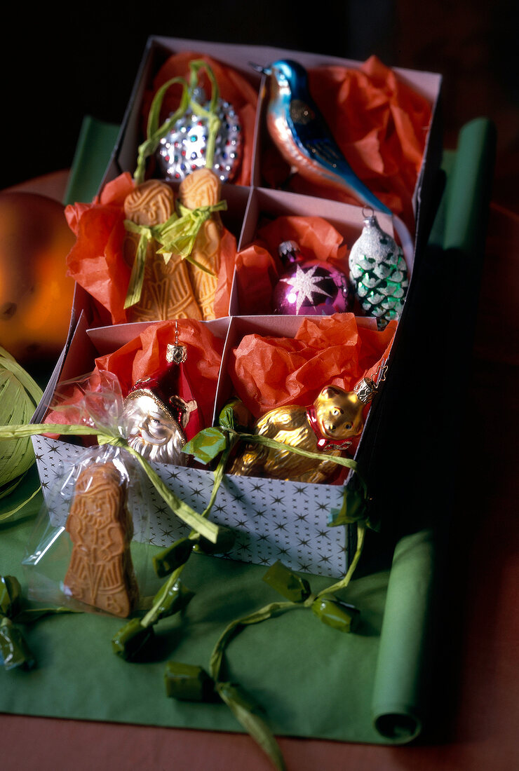 Box of Christmas decoration on green cloth