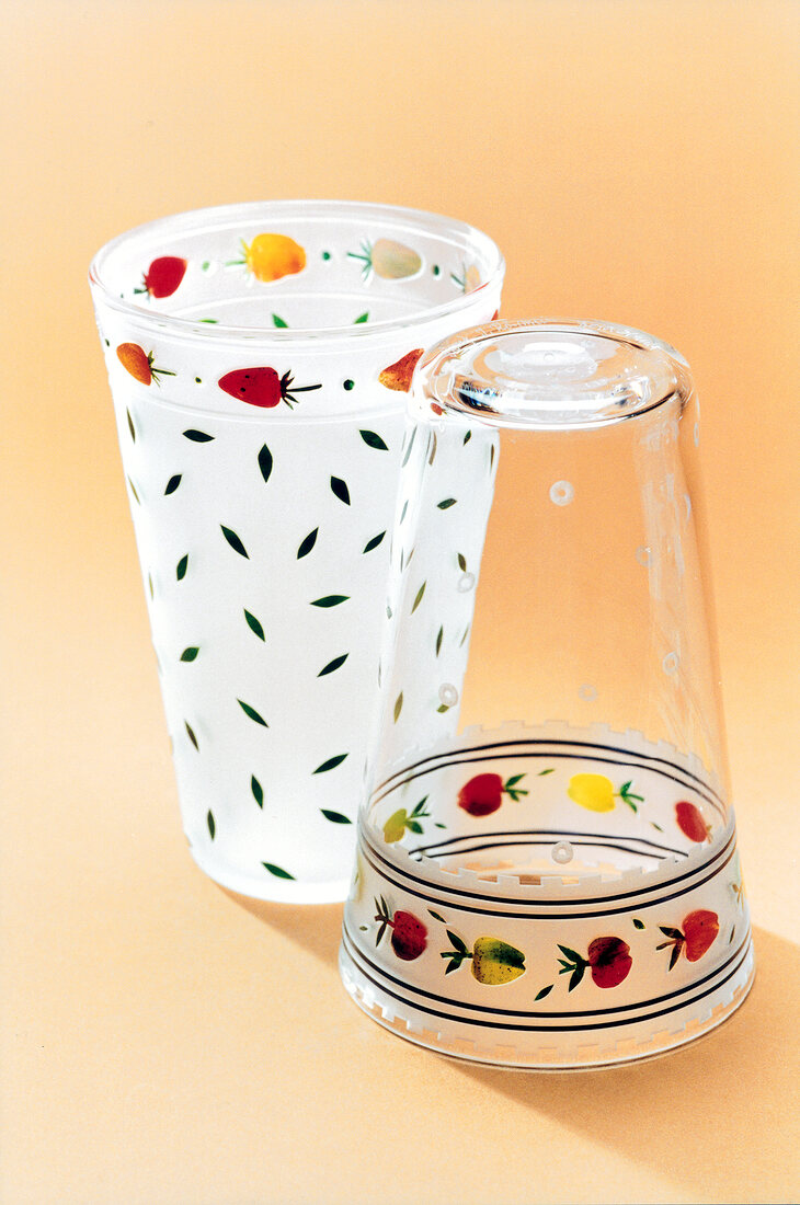 Close-up of glasses with fruit and leaf motifs