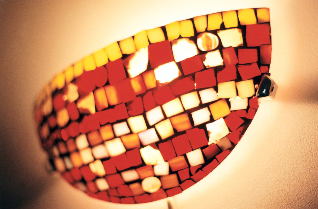 Close-up of mosaic wall light in shape of horizontal half moon