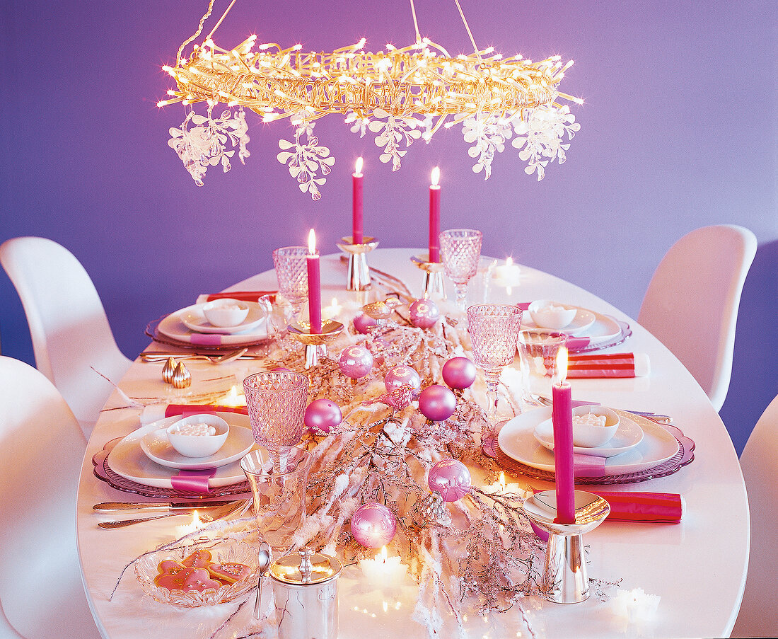 Table set festively with Christmas decorations and candles