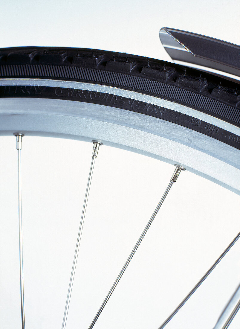 Close-up of aluminium rims and stainless steel spokes of touring bike 