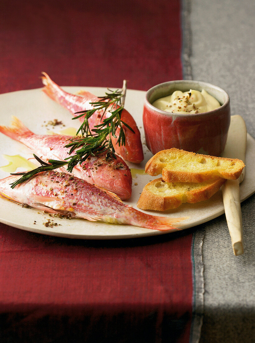 Close-up of red mullet with peppery and spicy aioli on plate