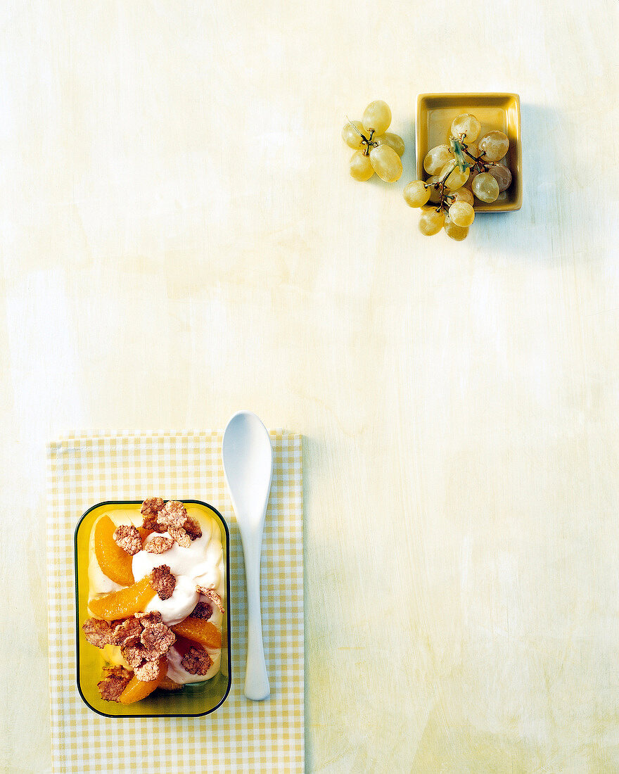 Grapes and orange curd with corn flakes in bowls, copy space