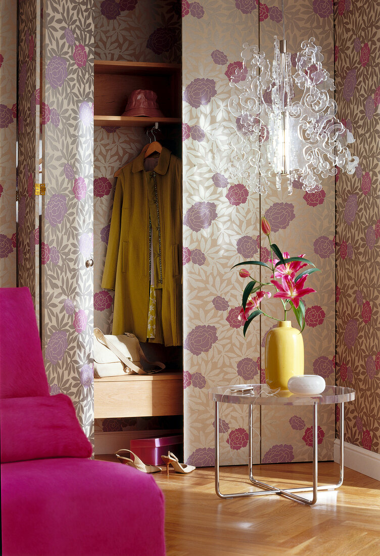 Wall cabinet with folding doors and floral wallpaper