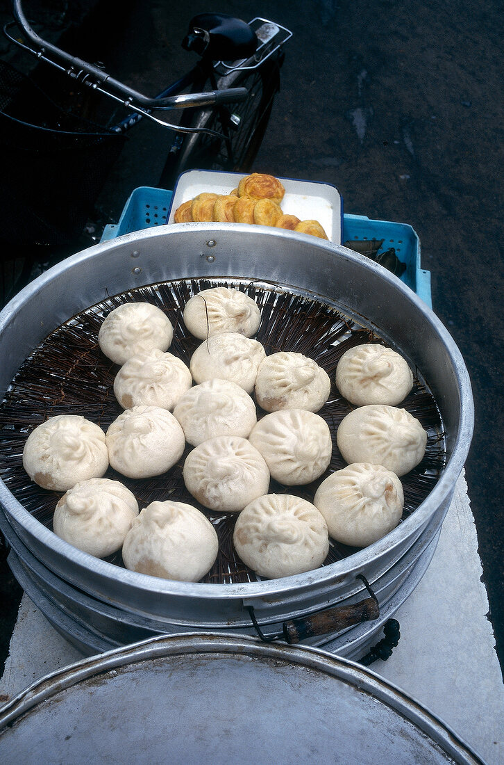 Dumplings in pot at food stall on streets of Shanghai