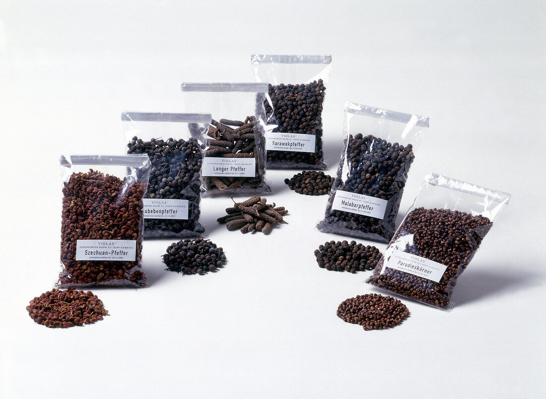 Rare types of pepper sealed in plastic packets on white background