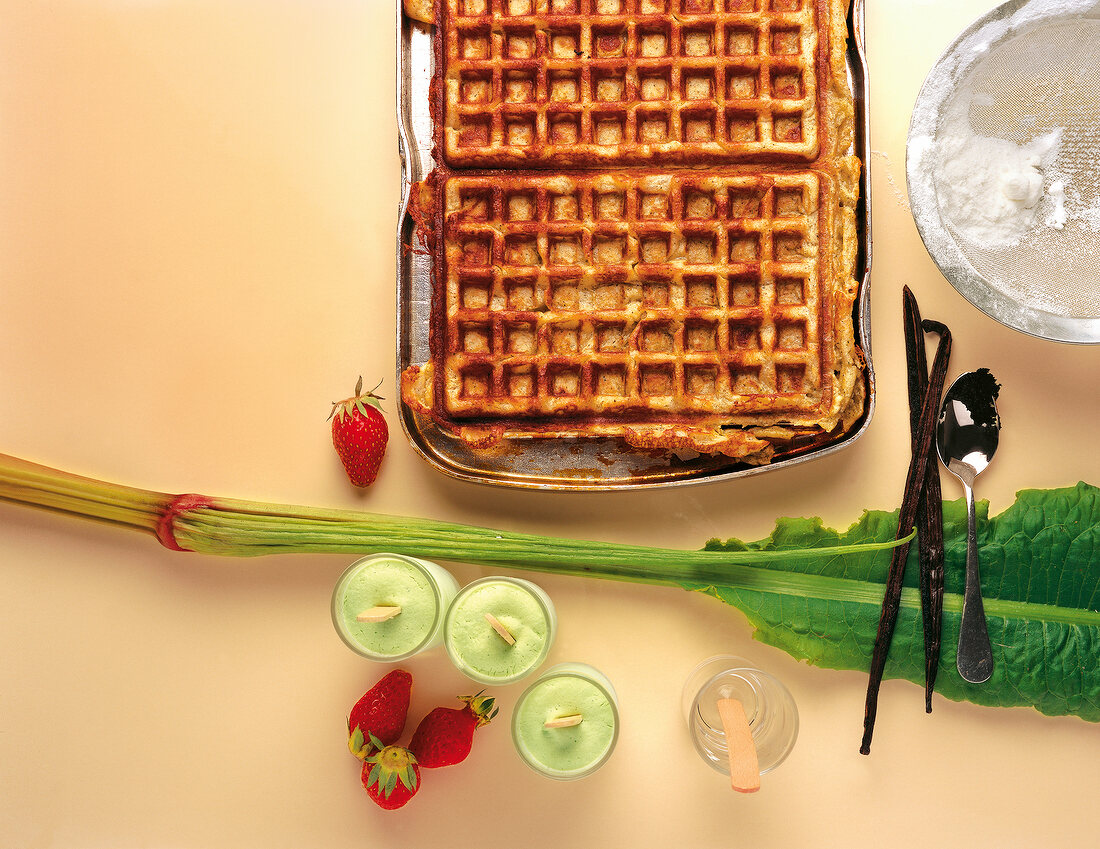 Preparation of waffles with strawberries, vanilla pods and basil