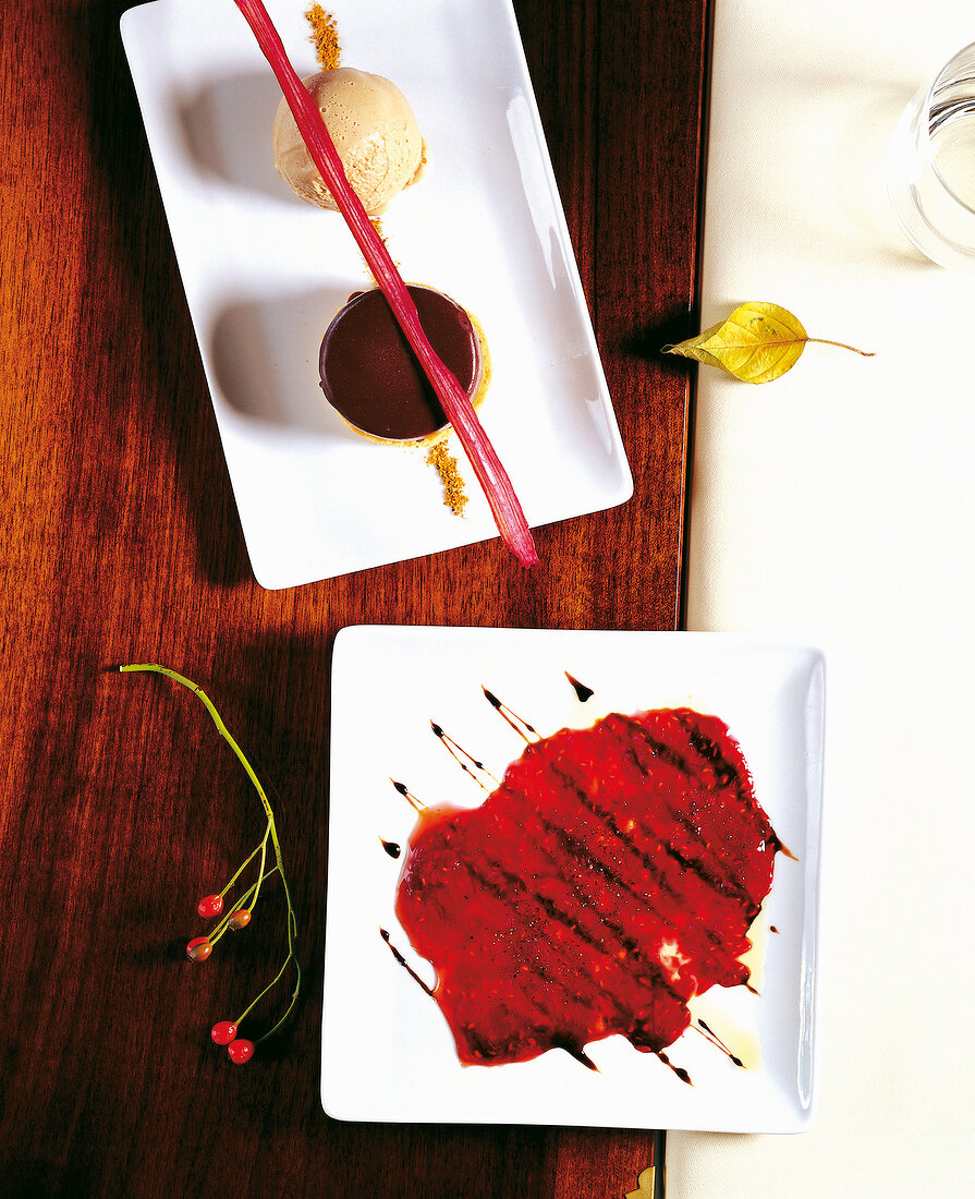 Chocolate marshmallow pastry filled with chocolate mousse and raspberry and carpaccio on plates