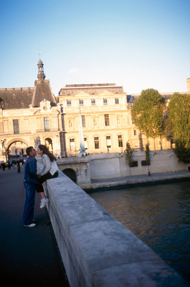 Couple kissing on bridge in Paris, France