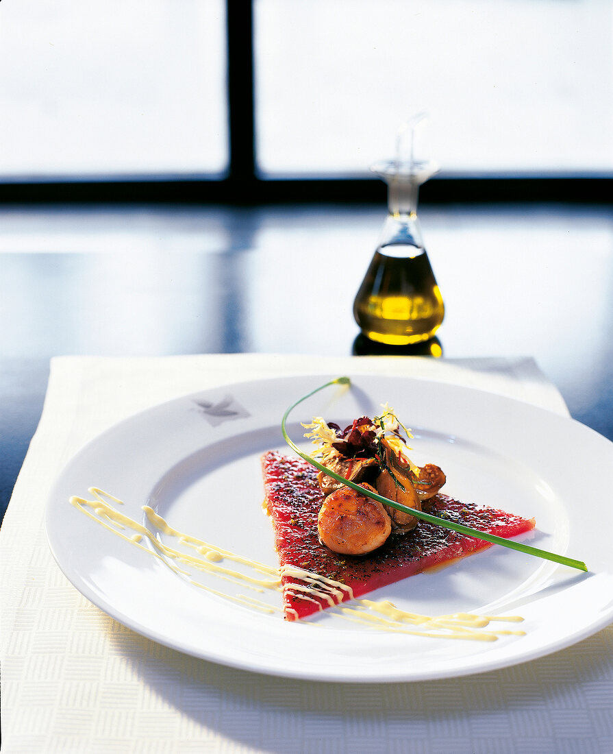 Tuna marinated with lime, poppy seeds and pickled eggplant on plate