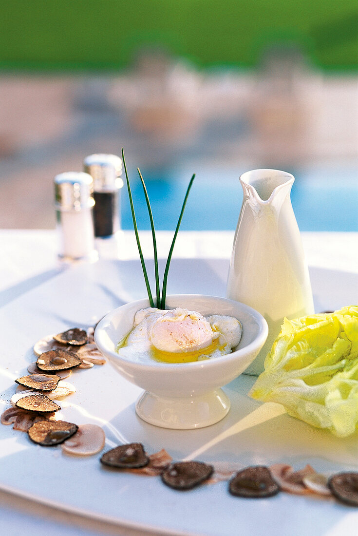 Bowl of eggs and mushrooms with summer truffle on plate