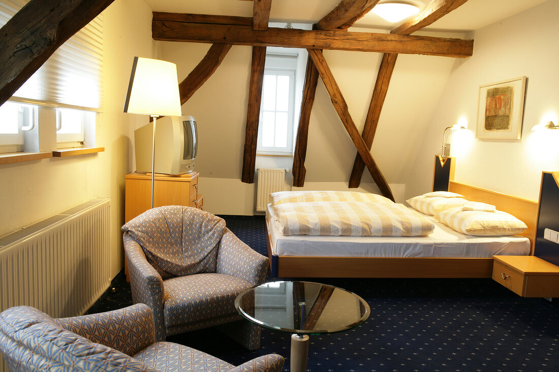 Bedroom of hotel with wooden ceiling, Germany