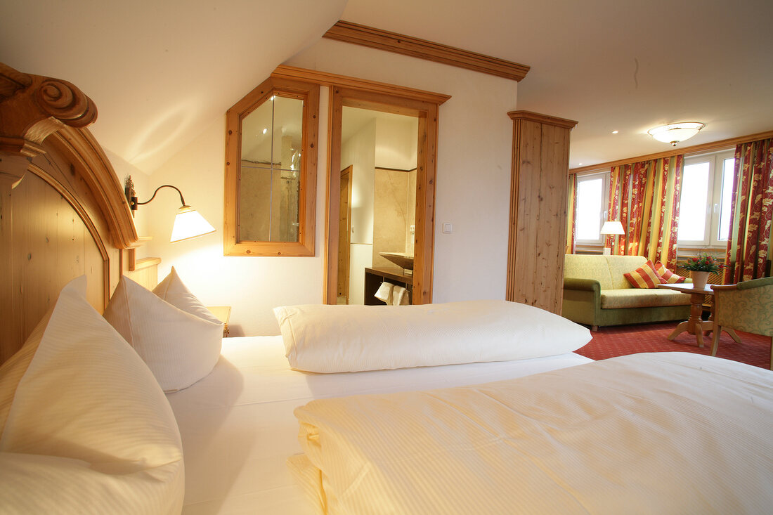 Bedroom with bed, cushion and lamp in hotel, Germany