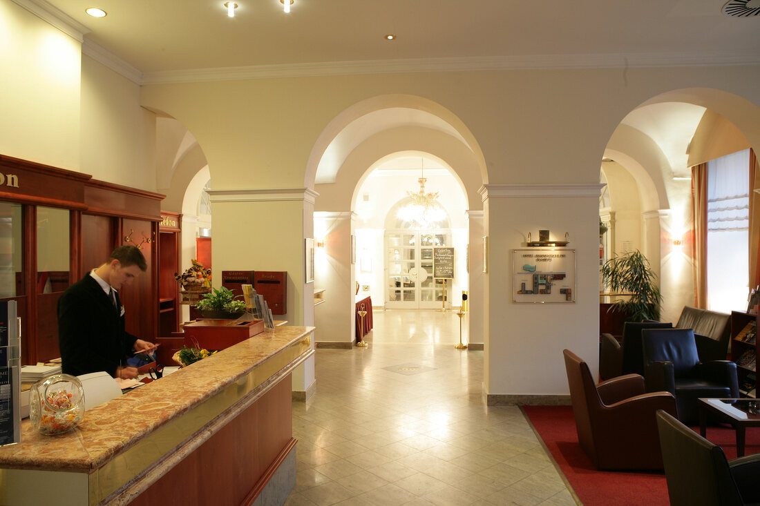 Man at reception of hotel, Germany