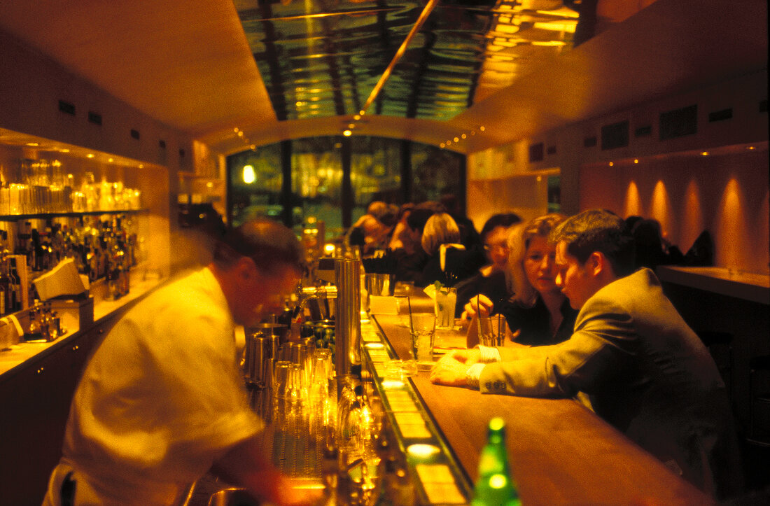 Guests at bar counter in Berlin, Germany