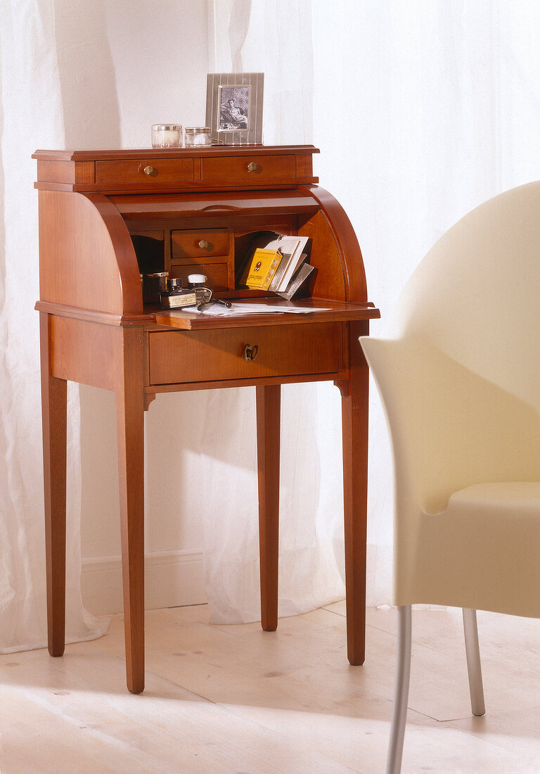 Secretary writing desk of cherry wood on white background