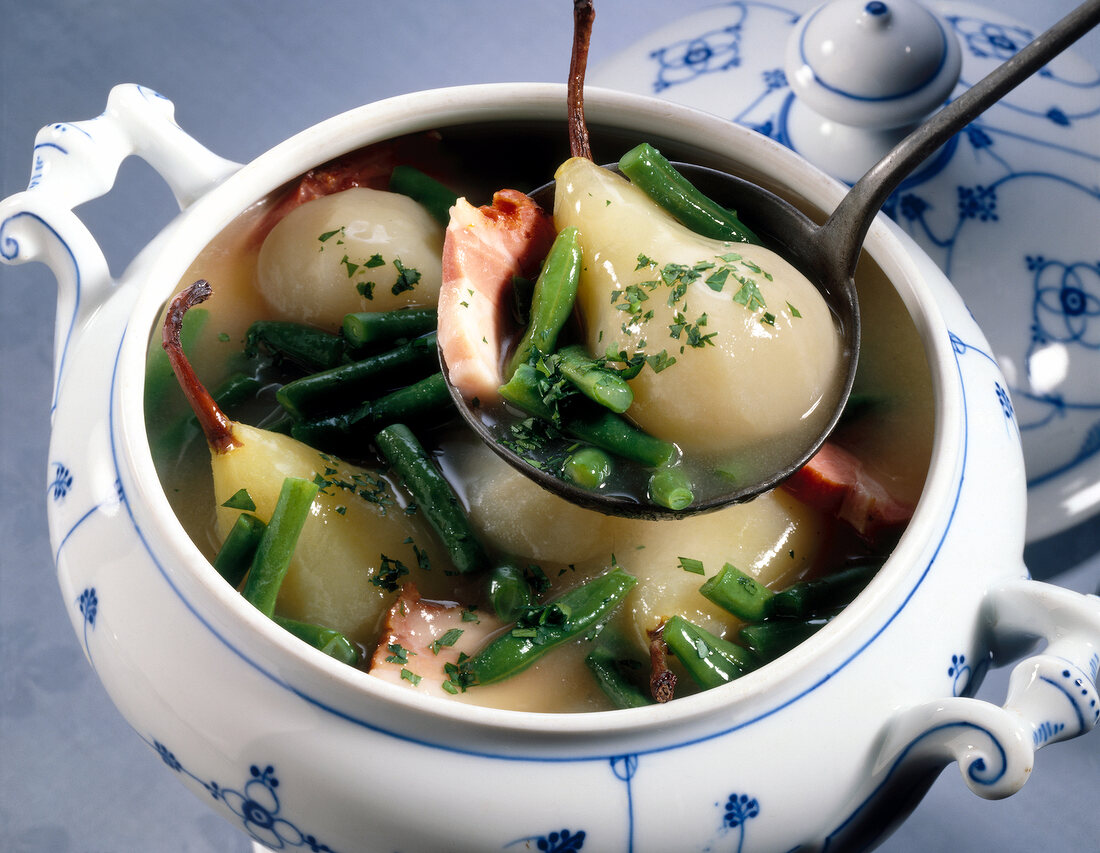 Close-up of stewed pears, beans and bacon in pot